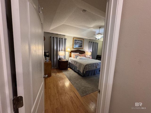 1052 Orlando Dr, Foley, AL 36535 - bedroom with wood finished floors, a tray ceiling, and ceiling fan