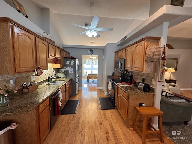 1052 Orlando Dr, Foley, AL 36535 - kitchen featuring black appliances, a sink, lofted ceiling, ceiling fan, and tasteful backsplash