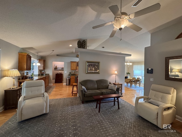 1052 Orlando Dr, Foley, AL 36535 - living room with light wood-style floors, lofted ceiling, a chandelier, a ceiling fan, and baseboards
