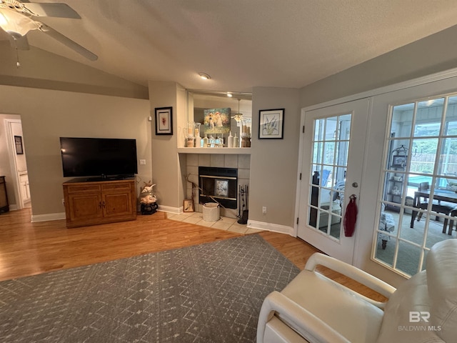 1052 Orlando Dr, Foley, AL 36535 - living area with wood finished floors, a ceiling fan, baseboards, and a tiled fireplace