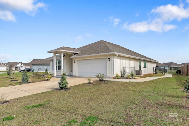 view of front facade featuring a garage, central AC, and a front lawn