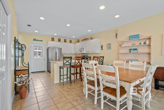 6065 Sawgrass Dr, Gulf Shores, AL 36542 - dining room featuring light tile patterned flooring, visible vents, and recessed lighting