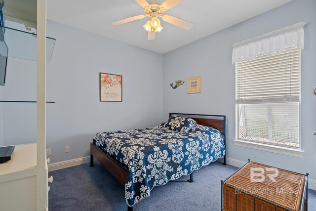 6065 Sawgrass Dr, Gulf Shores, AL 36542 - bedroom featuring ceiling fan, dark colored carpet, and baseboards