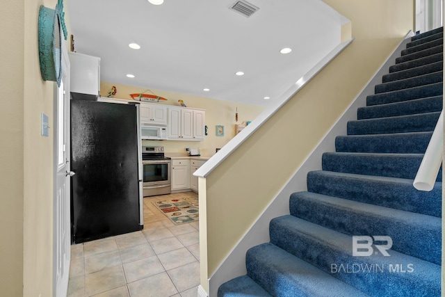 6065 Sawgrass Dr, Gulf Shores, AL 36542 - staircase featuring tile patterned flooring, visible vents, and recessed lighting
