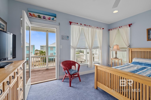 6065 Sawgrass Dr, Gulf Shores, AL 36542 - bedroom with baseboards, multiple windows, dark carpet, and access to exterior