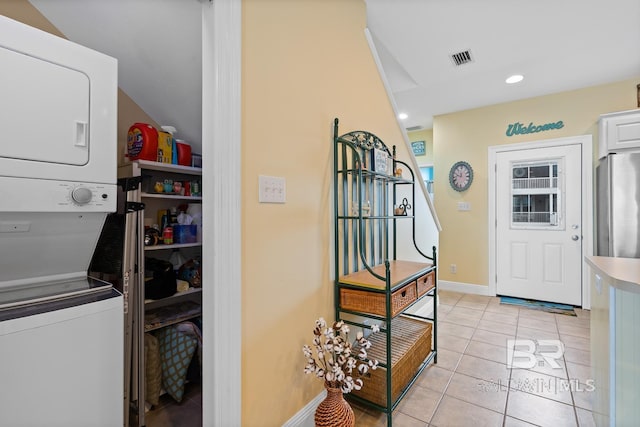 6065 Sawgrass Dr, Gulf Shores, AL 36542 - clothes washing area with light tile patterned floors, recessed lighting, laundry area, stacked washer / dryer, and visible vents