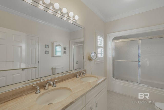 full bathroom featuring ornamental molding, vanity, bath / shower combo with glass door, tile patterned floors, and toilet