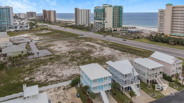 birds eye view of property with a view of the beach and a water view