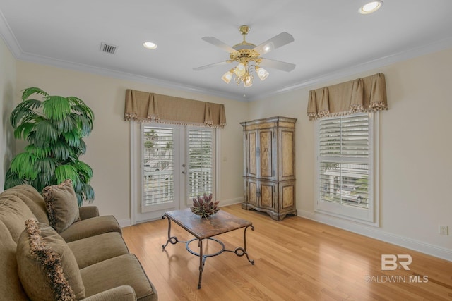 living room with ceiling fan, light hardwood / wood-style flooring, and ornamental molding