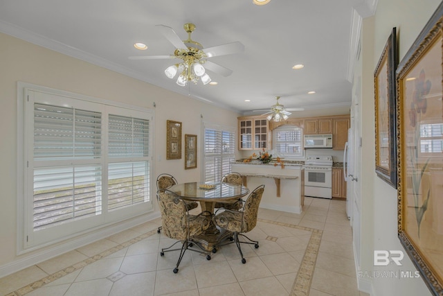 dining area featuring ceiling fan, light tile patterned floors, crown molding, and plenty of natural light