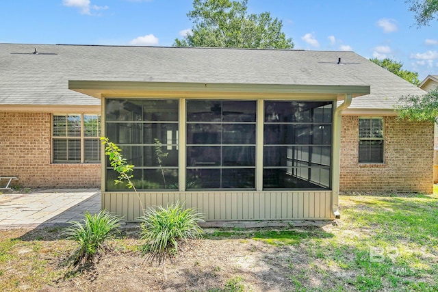 28165 Turkey Branch Dr, Daphne, AL 36526 - rear view of house with brick siding, a sunroom, a shingled roof, and a patio area