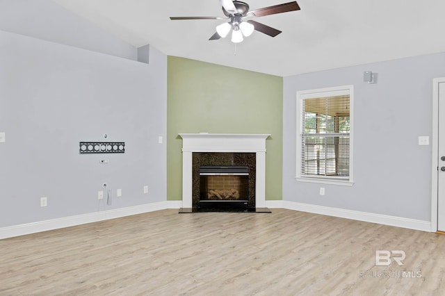 28165 Turkey Branch Dr, Daphne, AL 36526 - unfurnished living room with a ceiling fan, light wood finished floors, a premium fireplace, lofted ceiling, and baseboards