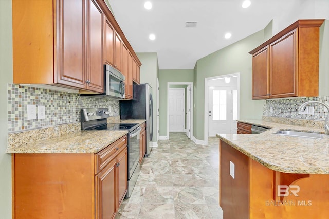 28165 Turkey Branch Dr, Daphne, AL 36526 - kitchen featuring stainless steel appliances, a sink, light stone counters, baseboards, and backsplash