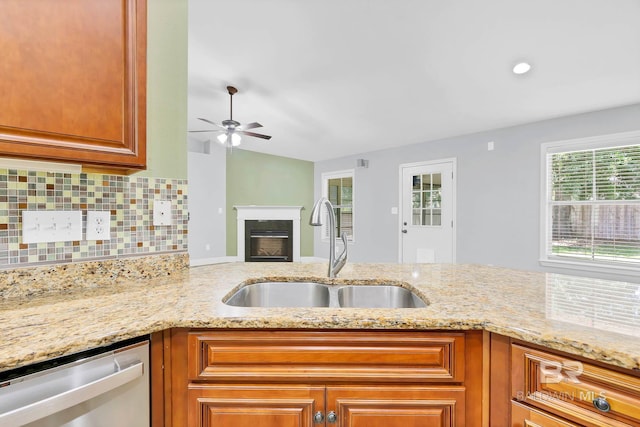 28165 Turkey Branch Dr, Daphne, AL 36526 - kitchen featuring stainless steel dishwasher, a sink, ceiling fan, light stone counters, and tasteful backsplash