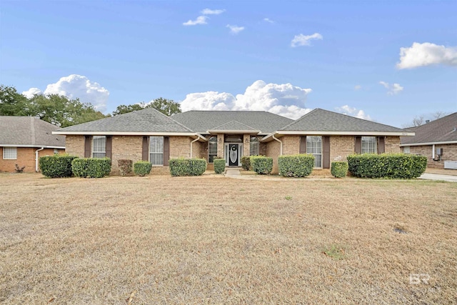 ranch-style home with a front lawn