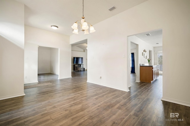 interior space featuring dark wood-type flooring and a notable chandelier