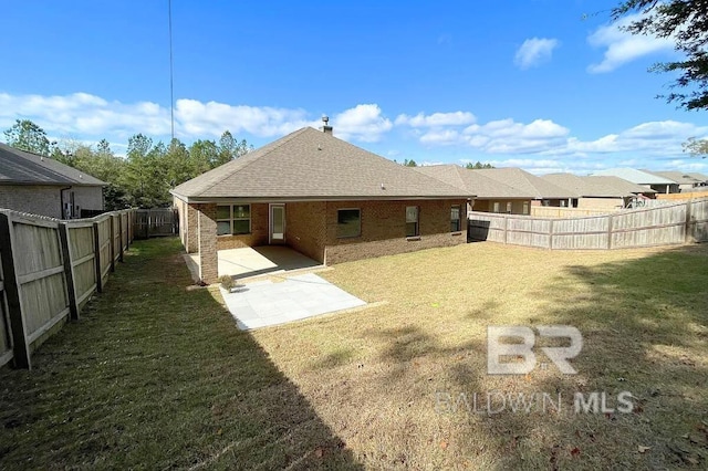 31820 Calder Ct, Spanish Fort, AL 36527 - rear view of property featuring a fenced backyard, a patio area, brick siding, and roof with shingles