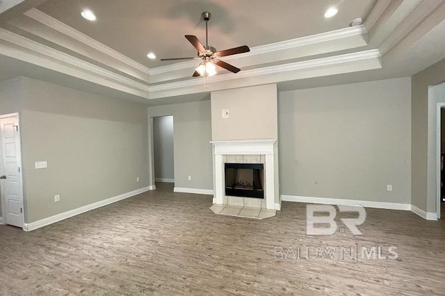 31820 Calder Ct, Spanish Fort, AL 36527 - unfurnished living room featuring a tray ceiling, ornamental molding, wood finished floors, a ceiling fan, and recessed lighting