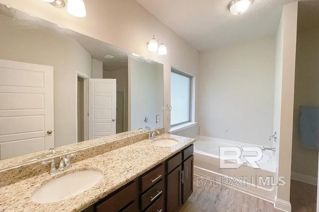 31820 Calder Ct, Spanish Fort, AL 36527 - bathroom featuring double vanity, a bath, and wood finished floors