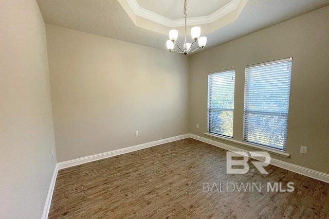 31820 Calder Ct, Spanish Fort, AL 36527 - unfurnished room with a raised ceiling, ornamental molding, a chandelier, and wood finished floors