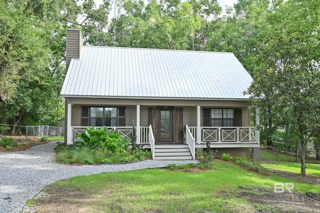 view of front facade with a front yard and covered porch