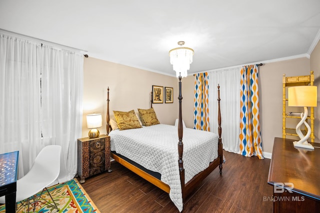 bedroom featuring dark hardwood / wood-style flooring, crown molding, and a chandelier