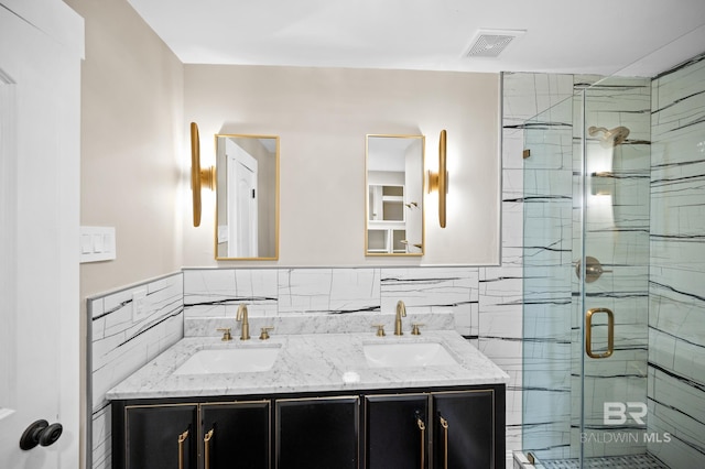 bathroom featuring tile walls, vanity, and walk in shower
