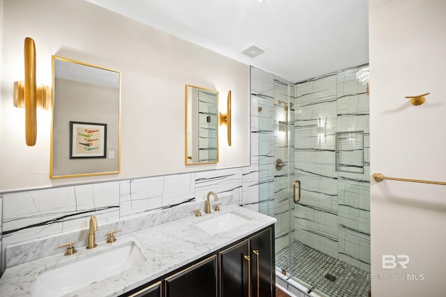 bathroom featuring vanity, tile walls, and a shower with shower door