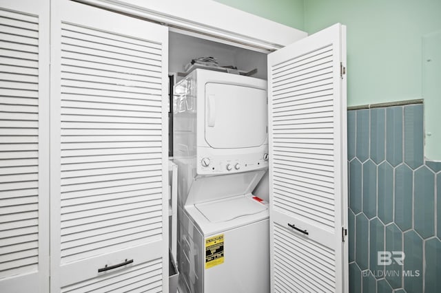 clothes washing area with stacked washer / drying machine
