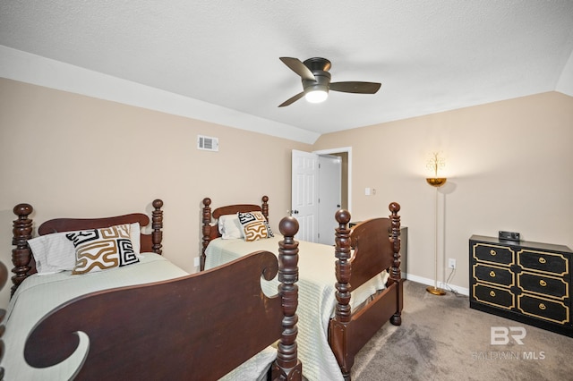 carpeted bedroom featuring ceiling fan, vaulted ceiling, and a textured ceiling