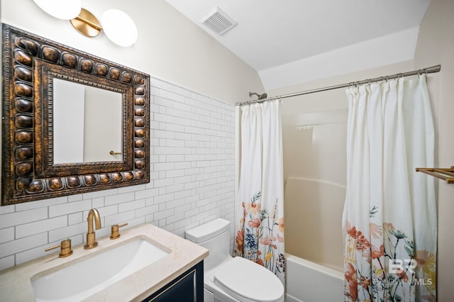 full bathroom featuring tile walls, backsplash, vanity, toilet, and shower / bath combo with shower curtain