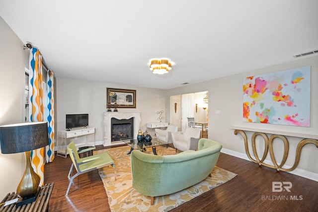 living room with hardwood / wood-style floors and a fireplace