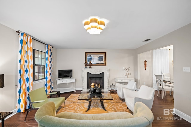living room with wood-type flooring and a fireplace
