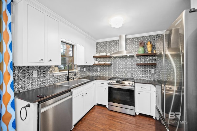 kitchen featuring sink, white cabinetry, crown molding, stainless steel appliances, and wall chimney range hood
