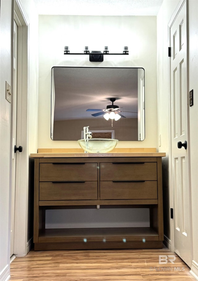 bathroom featuring vanity, ceiling fan, and hardwood / wood-style floors