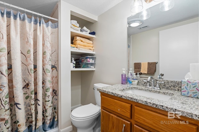 bathroom with vanity, toilet, and walk in shower