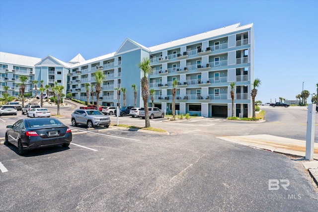 view of building exterior with uncovered parking