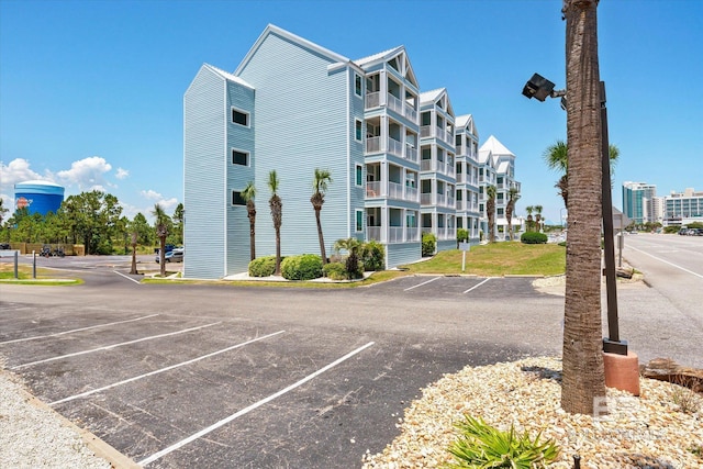 view of building exterior with uncovered parking