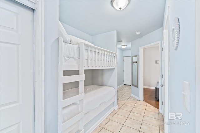 bedroom with tile patterned floors and baseboards