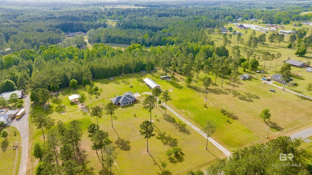 birds eye view of property featuring a view of trees