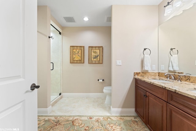 bathroom with an enclosed shower, vanity, tile floors, and toilet