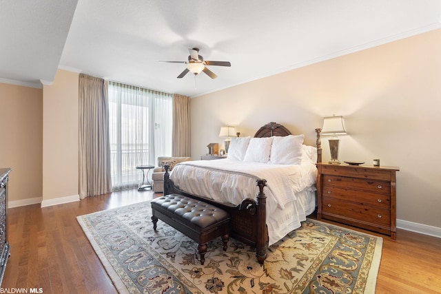 bedroom featuring hardwood / wood-style floors, ceiling fan, and crown molding