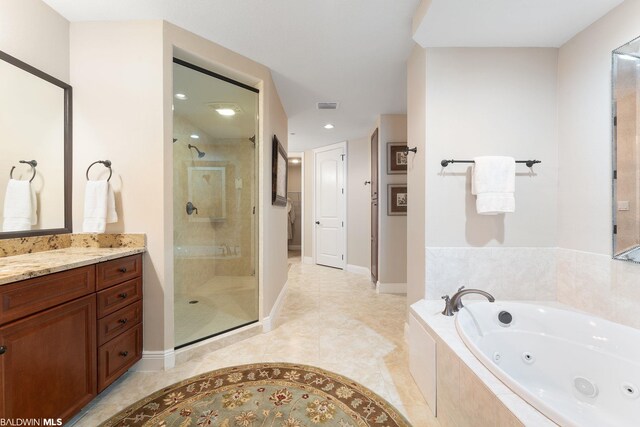 bathroom featuring separate shower and tub, tile floors, and vanity