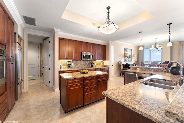 kitchen featuring decorative light fixtures, stainless steel appliances, sink, and light tile floors