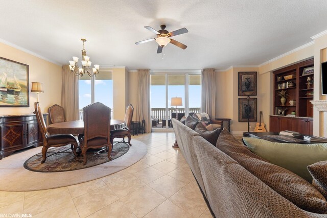 dining room featuring plenty of natural light, light tile floors, and ceiling fan with notable chandelier