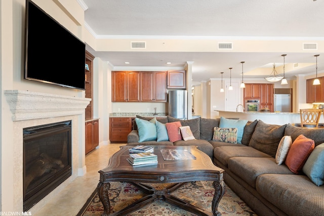 living room with ornamental molding and light tile floors