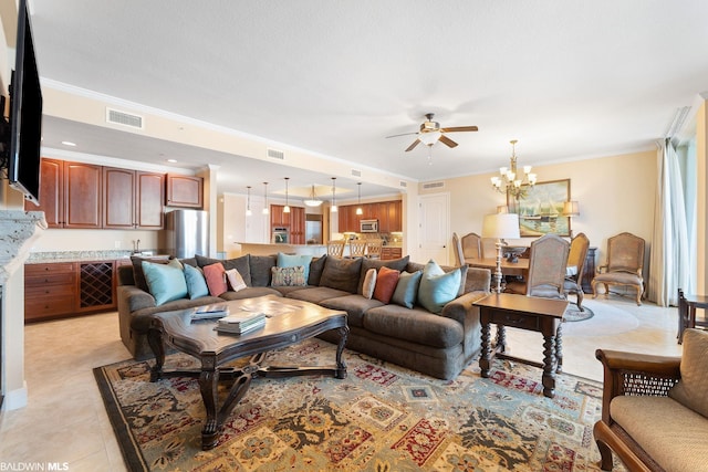 living room featuring ceiling fan with notable chandelier, light tile floors, and crown molding