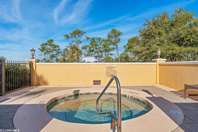 view of pool featuring a patio and a hot tub