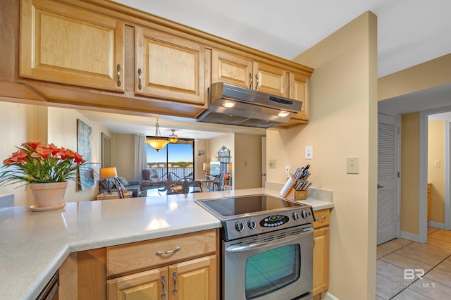 kitchen with under cabinet range hood, stainless steel electric stove, light countertops, and light tile patterned flooring