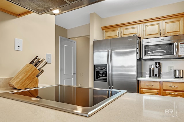 kitchen with wall chimney range hood, stainless steel appliances, and light countertops